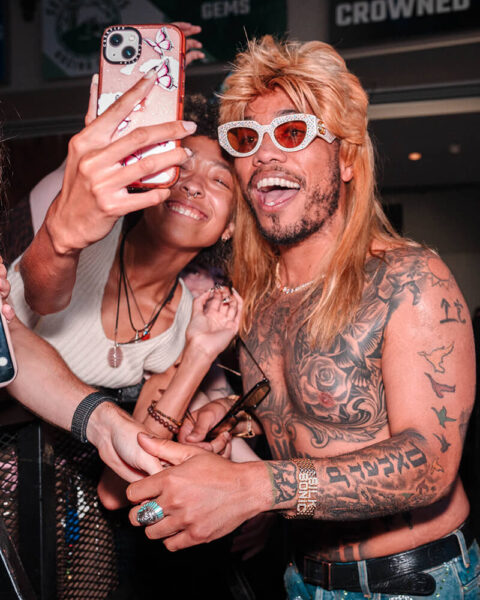 DJ Peewee posing for photo with fan at NTL event