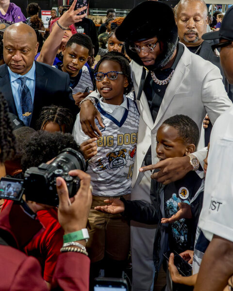 Lamar Jackson posing for photos with young fans